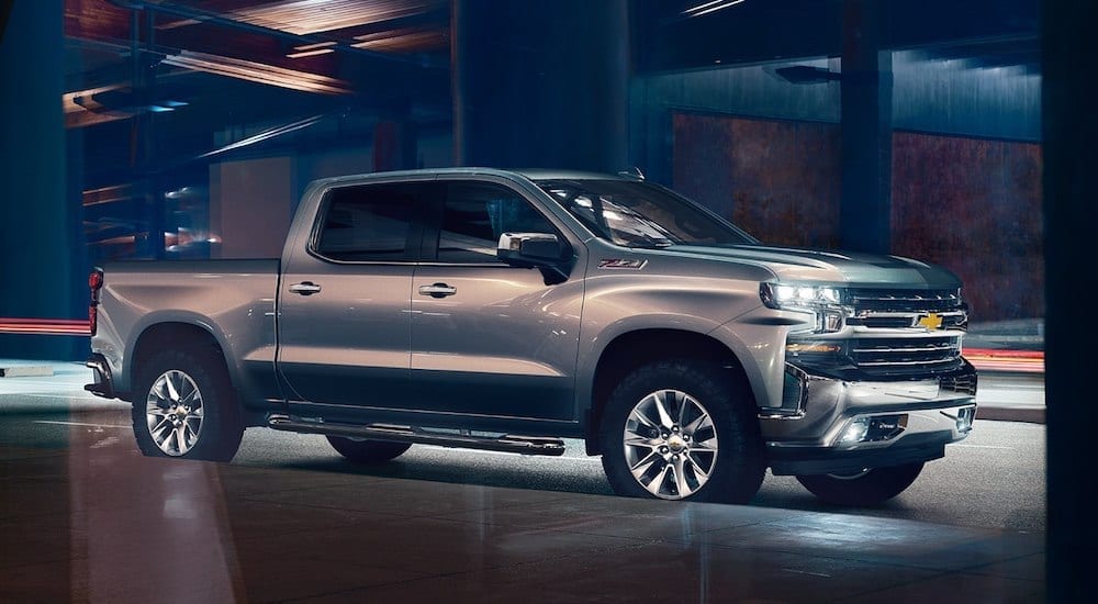 Silver 2019 Chevy Silverado under overpass