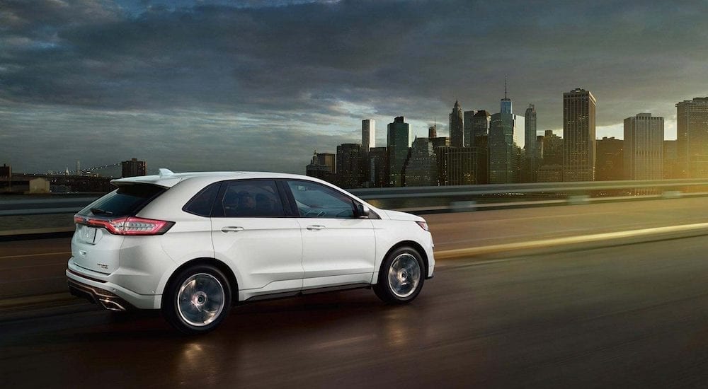White 2018 Ford Edge on highway with NYC cityscape in background
