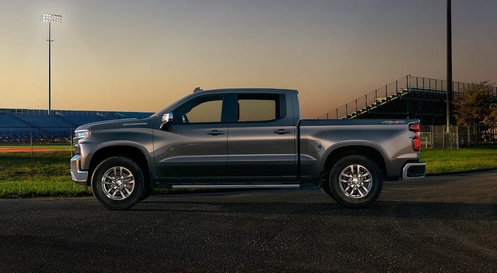 The brand new 2019 Chevy Silverado in front of a football filed at night