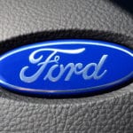 Closeup of the Ford logo on a steering wheel