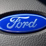 Closeup of the Ford logo on a steering wheel