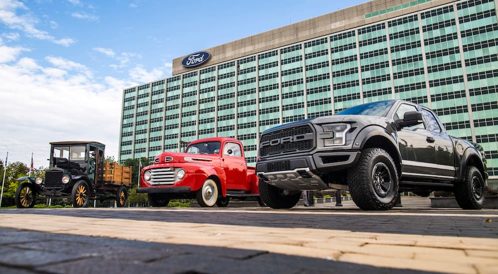 Antique Black Model TT, Red Ford 100, Black 2018 F-150 in front of Ford headquarters