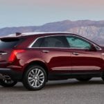 Dark red 2018 Cadillac XT5 overlooking mountains