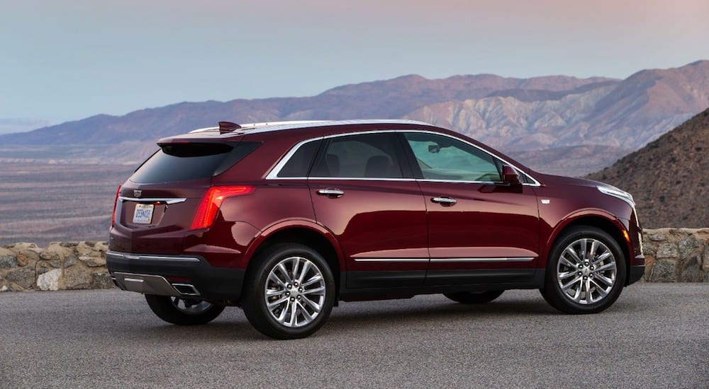 Dark red 2018 Cadillac XT5 overlooking mountains
