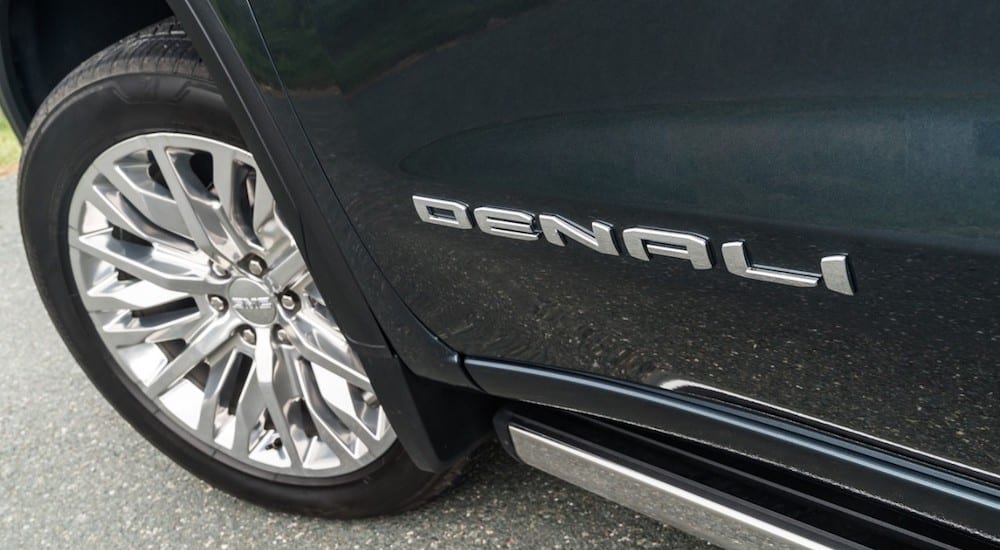 Closeup of "Denali" badge and wheel on 2019 GMC Sierra