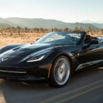 Black 2019 Chevrolet Corvette Stingray convertible driving on desert road