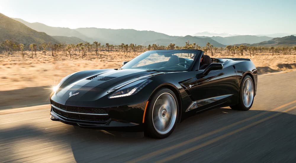 Black 2019 Chevrolet Corvette Stingray convertible driving on desert road