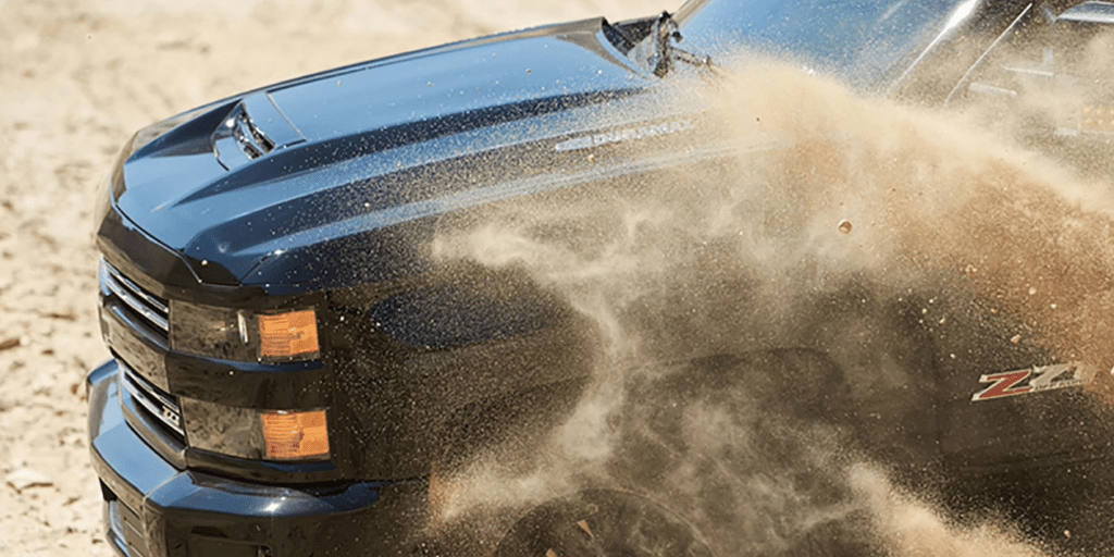 Black 2019 Chevy Silverado HD with dirt being kicked up from front wheel