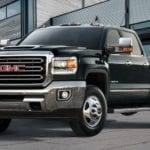Black 2019 GMC Sierra 3500HD in front of wood, glass and metal building
