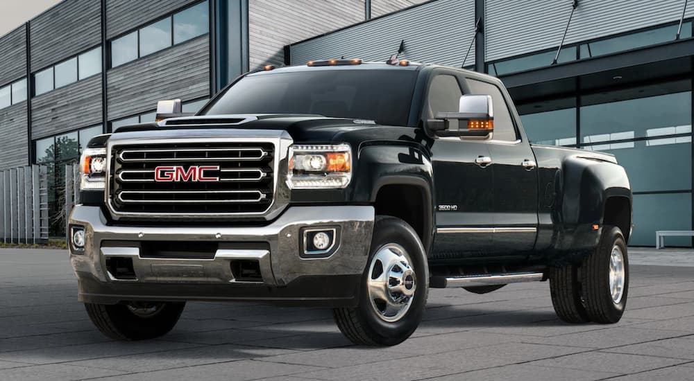 Black 2019 GMC Sierra 3500HD in front of wood, glass and metal building