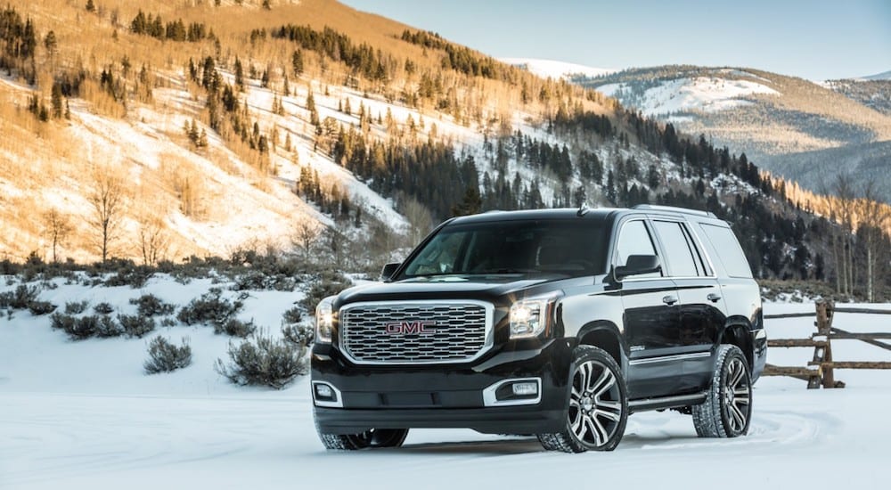 Black 2019 GMC Yukon Denali in snow covered mountains