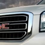 Closeup of GMC grille logo on white 2019 GMC Yukon