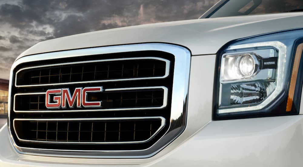 Closeup of GMC grille logo on white 2019 GMC Yukon