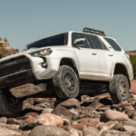White 2019 Toyota 4runner climbing over rocks