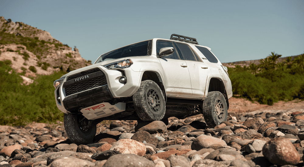 White 2019 Toyota 4runner climbing over rocks