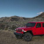 A red 2020 Jeep Gladiator in a rugged desert landscape