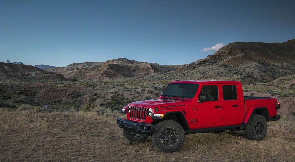 A red 2020 Jeep Gladiator in a rugged desert landscape