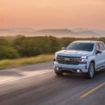 A white 2019 Chevy Silverado on a road at sunset