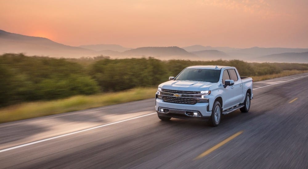 A white 2019 Chevy Silverado on a road at sunset