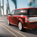A red 2019 Ford Flex driving on a bridge
