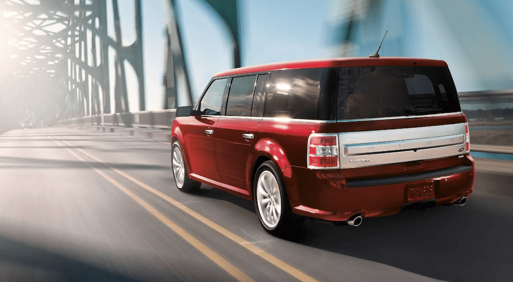 A red 2019 Ford Flex driving on a bridge
