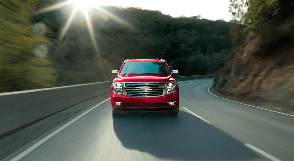 A red 2019 Chevy Tahoe whips around a winding road