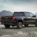 A black 2019 GMC Sierra AT4 parked with a view of mountains in the back, overlooking the win of 2019 GMC Sierra 1500 vs 2019 Toyota Tundra