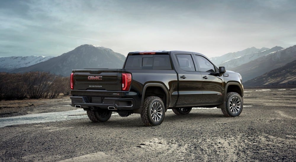 A black 2019 GMC Sierra AT4 parked with a view of mountains in the back, overlooking the win of 2019 GMC Sierra 1500 vs 2019 Toyota Tundra