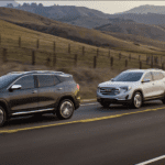 A group of GMC Terrains travel a hilly road