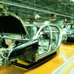 An assembly line for sedans at a plant is shown. manufacturing plants are frequently in current auto news.