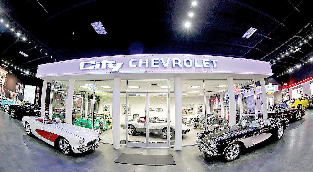 Classic cars in front of Rick Hendricks City Chevy dealership