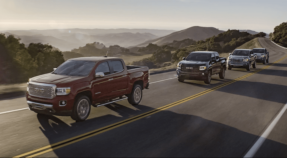 A group of GMC Canyons driving on a scenic road