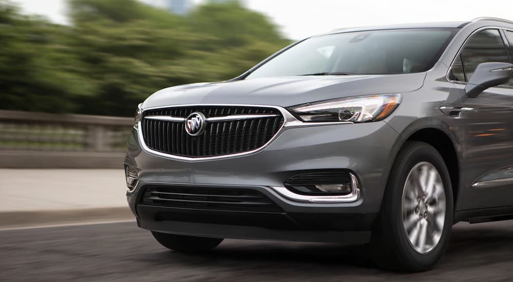 A grey 2019 Buick Enclave is shown from a front side angle driving.