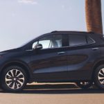 A black 2019 Buick Encore is shown in front of a bay.