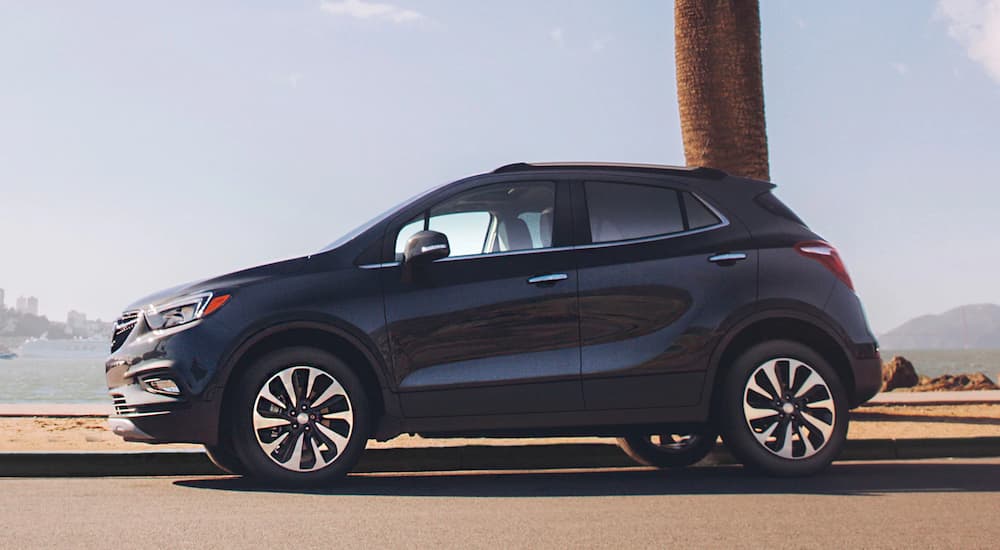 A black 2019 Buick Encore is shown in front of a bay.