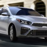 A silver 2019 Kia Forte is driving around traffic cones in Allentown, PA.