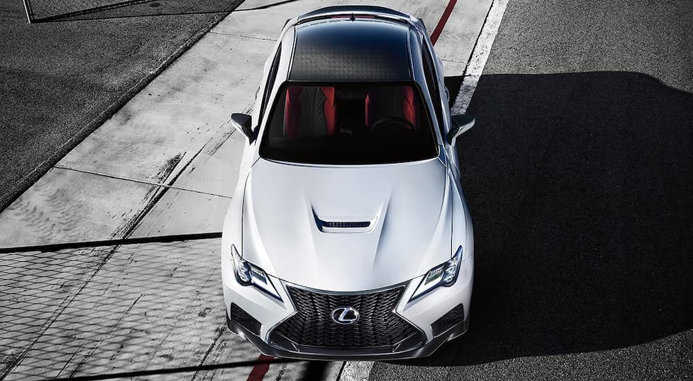 A white 2020 Lexus RCF is parked on a white strip of pavement shown from above.