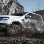 A white 2019 Ford Ranger, which wins when comapring the 2019 Ford Ranger vs 2019 Nissan Frontier, is shown in the mud.