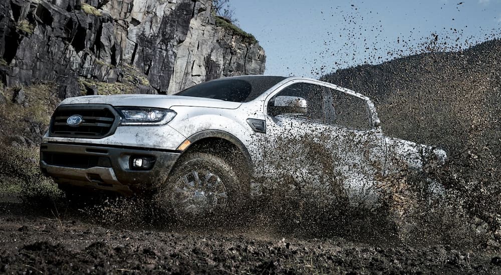 A white 2019 Ford Ranger, which wins when comapring the 2019 Ford Ranger vs 2019 Nissan Frontier, is shown in the mud.