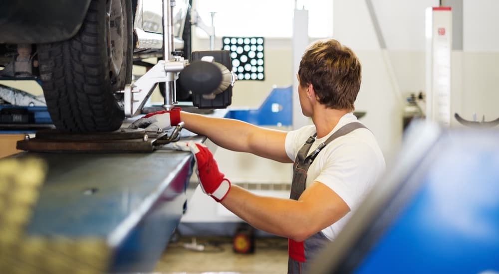 A mechanic is performing an alignment.