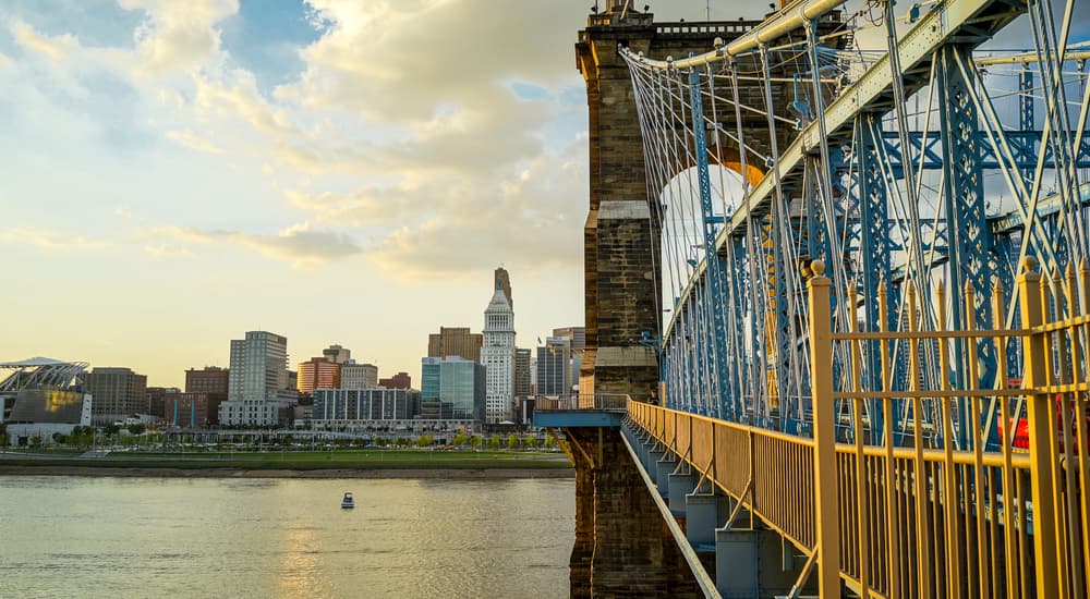 Cincinnati, OH is shown from the view of the Roebling Bridge.