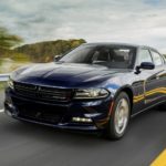 A blue 2017 Dodge Charger, popular among used cars near me, is on a highway.