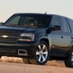 A black 2008 Chevy Trailblazer is on a dirt road.