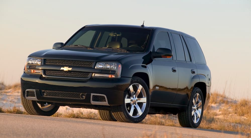 A black 2008 Chevy Trailblazer is on a dirt road.