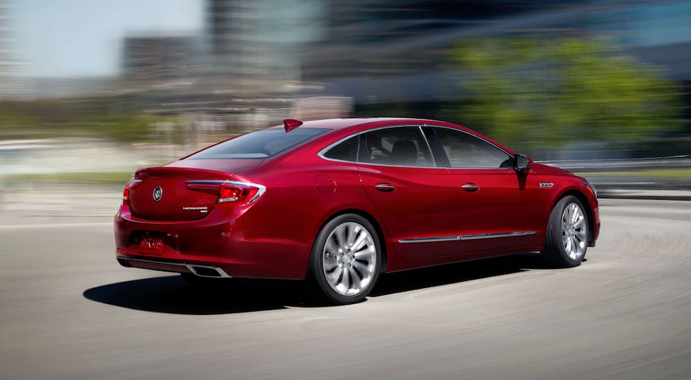 A red 2019 Buick LaCrosse is driving with a blurred background.