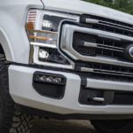 A close up of a white 2020 Ford Super Duty's grille.