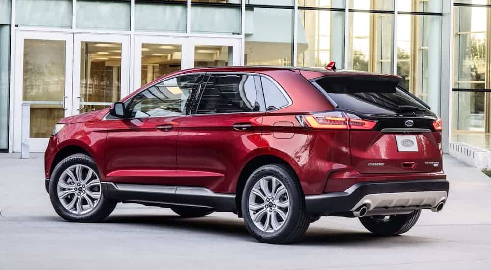 A red 2020 Ford Edge is parked outside of a Ford dealership.