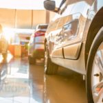 A close up used cars sitting in a showroom at a car dealership.