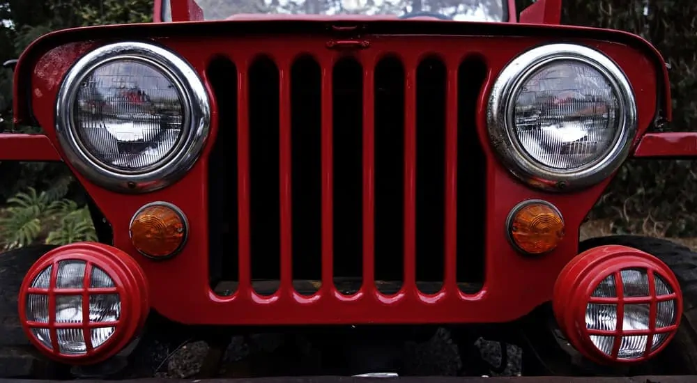 A close up of a red Jeep Willy's grille is shown.