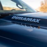 A close up of a Duramax badge on a 2020 Chevy Silverado 1500's hood is shown.